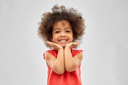 childhood and people concept - happy little african american girl over grey background