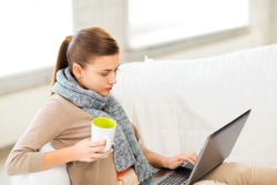 picture of diseased woman in scarf using laptop at home