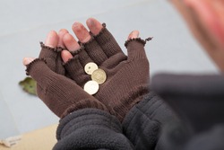 Homeless person holding a few cents in his hands
