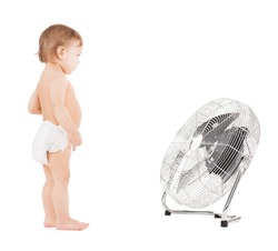 childhood, home concept - cute little boy with big cooling fan