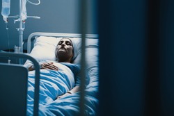 Weak woman with cancer dying alone in hospital bed