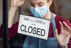 Stressed owner forced to close the restaurant permanently due to restrictions on the coronavirus. Depressed businesswoman closing her business activity due to covid-19. Small business bankrupt.