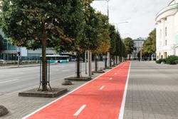traffic, road marking and city concept - bike lane or red road for bicycles on street in tallinn, estonia