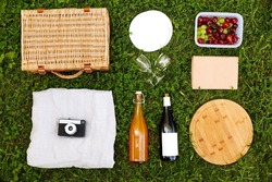 leisure and summer concept - close up of food, drinks and picnic basket on grass