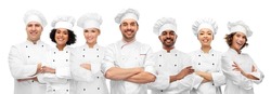 cooking, culinary and profession concept - international team of smiling chefs with crossed arms