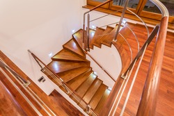 Close-up of winding wooden stairs in luxury mansion