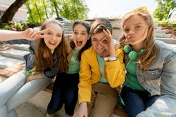 friendship and people concept - happy teenage friends or high school students having fun and making faces