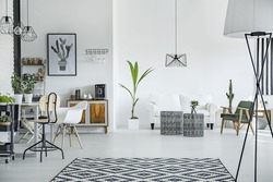 White loft interior in scandinavian style with pattern carpet