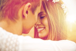 summer holidays, love, romance and people concept - happy smiling young hippie couple hugging outdoors