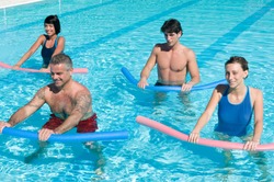 Healthy group of people exercising with aqua tube in a swimming pool
