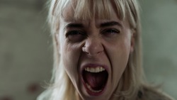 Beautiful Young Caucasian Woman Screaming Out of Anger Straight in the Camera. Girl in Agony Releasing Her Emotions While in Tears. Blonde Sad Girl with Anxiety.