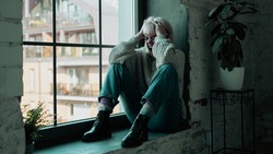 Beautiful Young Caucasian Woman Screaming Out of Anger While Sitting By a Window. Girl in Agony Releasing Her Emotions While in Tears. Blonde Sad Girl with Anxiety.