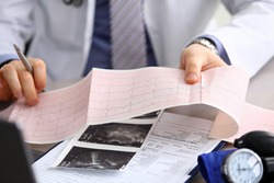 Doctor explains cardiogram data, consultation. Repeated consultation, doctor develops an optimal treatment regimen, explains how to properly control state health. Prevention, treatment heart disease.