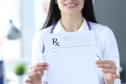 Doctor is holding prescription form for medicines. Prescription drug concept