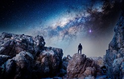 man standing on the top of the mountain, back view, staring the Milky Way and shooting star