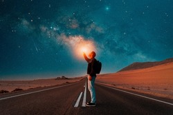 person on the road under the milky way at night