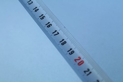 A white tape measure tool contains centimeters and millimeters
