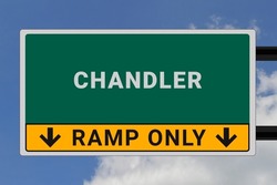 Chandler logo. Chandler lettering on a road sign. Signpost at entrance to Chandler, USA. Green pointer in American style. Road sign in the United States of America. Sky in background