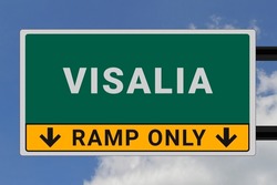 Visalia logo. Visalia lettering on a road sign. Signpost at entrance to Visalia, USA. Green pointer in American style. Road sign in the United States of America. Sky in background