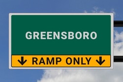 Greensboro logo. Greensboro lettering on a road sign. Signpost at entrance to Greensboro, USA. Green pointer in American style. Road sign in the United States of America. Sky in background