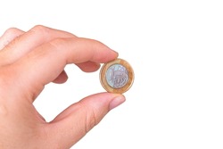 One real coin in the palm of a person's hand. Hand holding a 1 dollar coin. Real is the currency system of the Brazilian Government. Isolated Blank Background