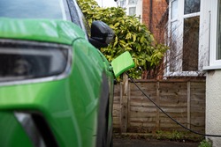 Green Electric Car On Charge At Home