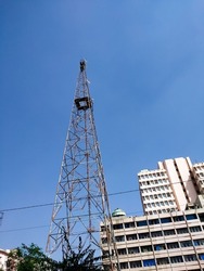 High metall radio antenna tower or Signaling, cell phone antenna system., Large transmission poles against blue sky.