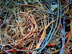 Messy pile of colorful cables network chaos of multicolor wires red, blue, yellow,black cable wires.