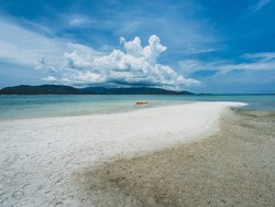 Wanderlust. Wide angle of white sand beach tropical paradise island with faraway yellow kayak on a long sandbank and mountain under fluffy cloudy sky background. Koh Mat Sum, Near Koh Samui, Thailand.