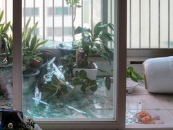 Broken glass window in an apartment due to typhoon