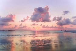 Beach on dusk with pink sanset sky