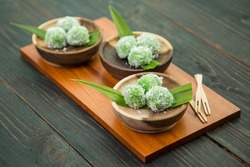 Klepon is a traditional rice cake ball filled with molten palm sugar and coated in grated coconut from Java, Indonesia.