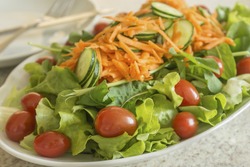 Salad with cherry tomato, lettuce, cucumber and grated carrot