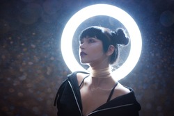 concept of artificial life. Beautiful young woman, futuristic style. Portrait against a glowing circle