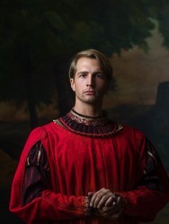handsome man in a Royal red doublet. Young man, portrait in Renaissance style paintings