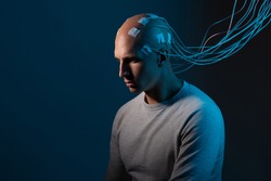 man with electrodes in his head is a futuristic concept of virtual reality and mind control. Neuro interface, contact of biological and mechanical