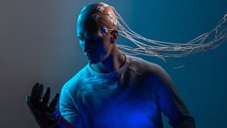bald man with electrodes in his brain, a man of the future with technological additions, the brain is connected to virtual reality. man with a mechanical arm, augmentations