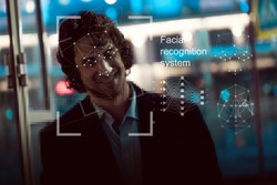 Facial recognition system, concept. Young man on the street, face recognition