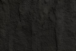 Craggy rock surface texture background. Rough black rock surface background.