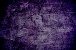Scary horror grunge background. Cracked rock surface texture in the dark.