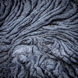 Interesting pattern of fissures formed in a lava rock, Hvaleyri beach, Hafnarfjordur, Iceland. 
