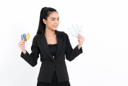 Portrait asian business woman with showing bunch of money banknotes and holding credit card in hand isolated on white background. Concept business and credit.