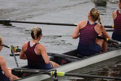 Athletes in the sport of rowing. Female rowing athletes in professional style. They work as a team to win.