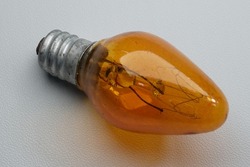 Yellow incandescent lamp with 5 watts of power on isolated white background