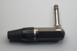 Black and silver guitar jack or instrument jack, male jack plug on white background isolated, closeup macro shot
