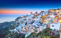 Church of Santorini. Fira town on Santorini island, Greece. Incredibly romantic sunset on Santorini. Oia village in the morning light. Amazing sunset view with white houses. Island lovers