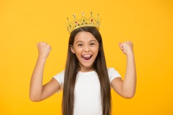 Just look at me. Princess concept. Girl princess. Lady little princess. Compelling baby. Kid wear golden crown symbol of princess. Girl cute baby wear crown yellow background. Success and happiness.