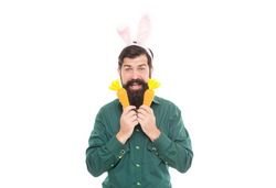 Cuter than any bunny. spring holiday greeting. eastertide. happy bearded man wear bunny ears. happy easter. easter carrot. hipster wearing rabbit ears. time for fun. cheerful guy holding carrots.
