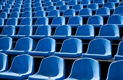 empty outdoor arena. concept of fans. chairs for audience. cultural environment concept. color and symmetry. empty seats. modern stadium. blue tribunes. seats of tribune on sport stadium