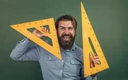 measure and size. happy mature teacher holding triangle tool. bearded man work in classroom with ruler. prepare for geometry exam. college lecturer on math lesson. back to school. formal education